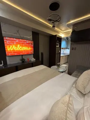 a hotel room with a large bed and a television at The Crystal Cove Cabin in Puting Kahoy
