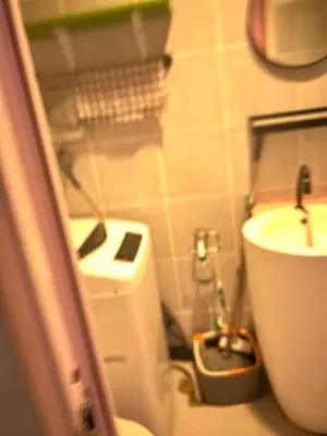 a small bathroom with a toilet and a sink at Chay place sea residence in Manila