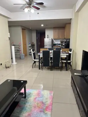 a dining room and kitchen with a table and chairs at Chay place sea residence in Manila