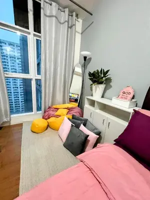a bedroom with a bed and a large window at StudioUnit Near Airport up to 3pax WiFi in Manila