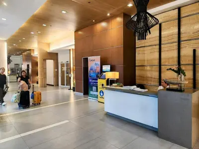 a lobby with a reception desk and people in a building at StudioUnit Near Airport up to 3pax WiFi in Manila