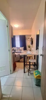 a kitchen and living room with a table and a couch at G and A CONDOTELS in Manila