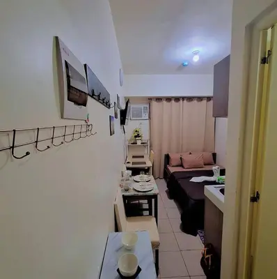 a small living room with a couch and a table at G and A CONDOTELS in Manila