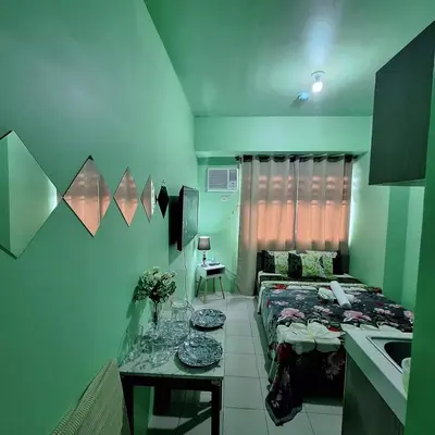 a room with a bed and a sink in it at G and A CONDOTELS in Manila