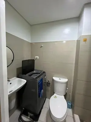 a small bathroom with a toilet and a sink at shore 2 tower 1 in Manila