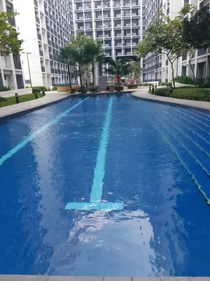 a swimming pool with blue water in a city at shore 2 tower 1 in Manila