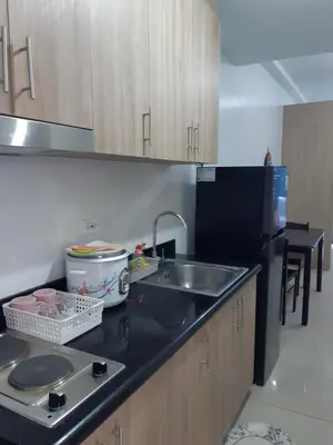 a kitchen with a sink and a counter top at shore 2 tower 1 in Manila