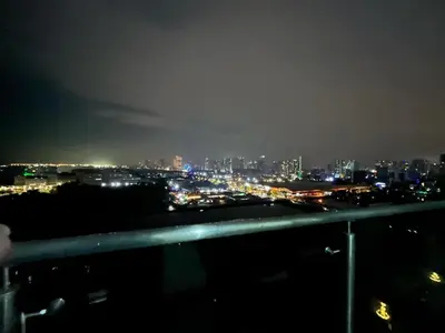 a view of a city at night with lights at shore 2 tower 1 in Manila
