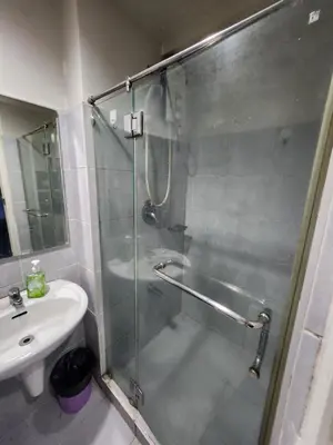 a bathroom with a shower and a sink at MNM Place in Manila