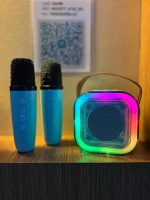 two microphones sitting next to a tv on a shelf at MNM Place in Manila