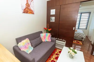 a living room with a couch and a table at Air Residence Penthouse 59 Suite Gym Swim Park 300 mbps in Manila