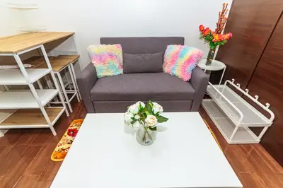 a living room with a chair and a table at Air Residence Penthouse 59 Suite Gym Swim Park 300 mbps in Manila