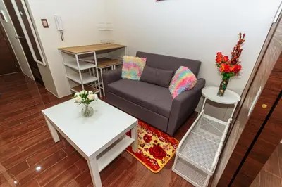 a living room with a couch and a table at Air Residence Penthouse 59 Suite Gym Swim Park 300 mbps in Manila