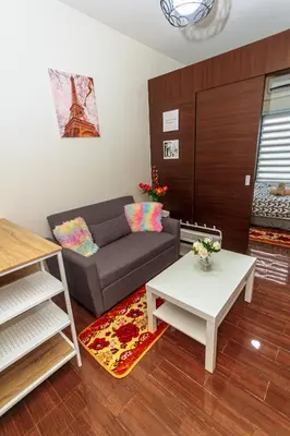 a living room with a couch and a table at Air Residence Penthouse 59 Suite Gym Swim Park 300 mbps in Manila