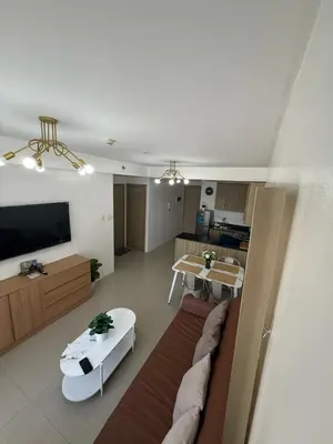 a living room with a couch and a table at Spacious 2BR Suites at MOA in Manila