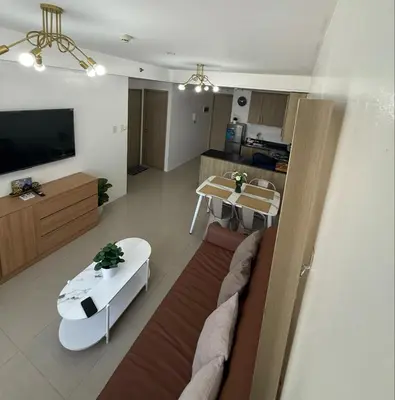 a living room with a couch and a table at Spacious 2BR Suites at MOA in Manila