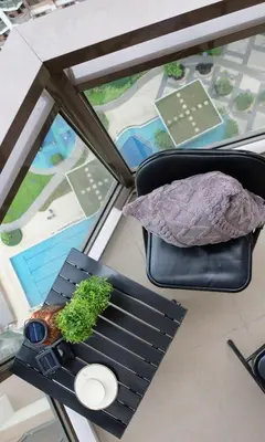 a table with a plant on top of a window at ModernAestheticPicc MoaCcpAirportPool Wi-Fi in Manila