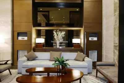 a living room with a couch and a table at ModernAestheticPicc MoaCcpAirportPool Wi-Fi in Manila