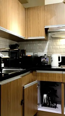 a kitchen with an open cabinet in a kitchen at ModernAestheticPicc MoaCcpAirportPool Wi-Fi in Manila