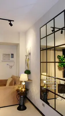 a living room with a table and a large window at ModernAestheticPicc MoaCcpAirportPool Wi-Fi in Manila