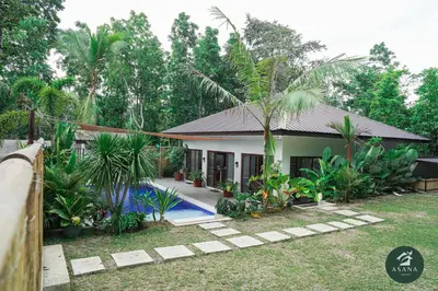 a house with a pool in front of it at Asana Amadeo a private villa near Tagaytay in Amadeo