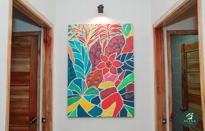 a painting of flowers on a wall next to two doors at Asana Amadeo a private villa near Tagaytay in Amadeo