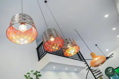 a group of lights hanging from a ceiling at Asana Amadeo a private villa near Tagaytay in Amadeo