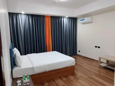 a bedroom with a bed and a window with curtains at Hotel S Casiana Residences in Manila