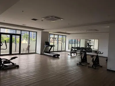 a gym with treadmills and exercise equipment in a room at Hotel S Casiana Residences in Manila
