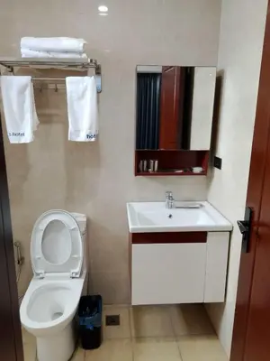 a small bathroom with a toilet and a sink at Hotel S Casiana Residences in Manila