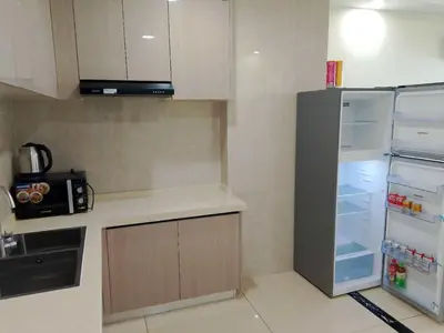 a kitchen with an open refrigerator with its door open at Hotel S Casiana Residences in Manila
