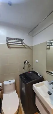 a bathroom with a toilet and a sink at 2 Bedroom Mall of Asia and Airport in Manila