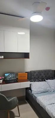 a bedroom with a bed and a desk and a chair at 2 Bedroom Mall of Asia and Airport in Manila