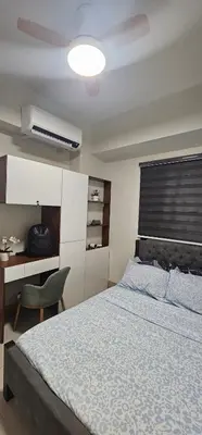 a bedroom with a bed and a desk and a bed sidx sidx sidx at 2 Bedroom Mall of Asia and Airport in Manila
