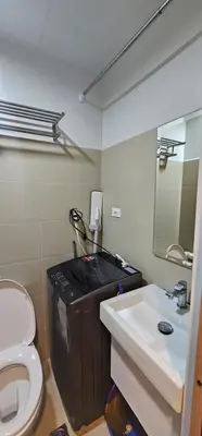 a bathroom with a toilet and a sink and a mirror at 2 Bedroom Mall of Asia and Airport in Manila