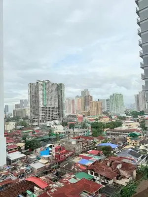 a city skyline with tall buildings and buildings at Comfortable Cozy Staycation in Manila