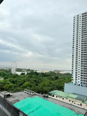 an aerial view of a building and a ferris wheel at Comfortable Cozy Staycation in Manila