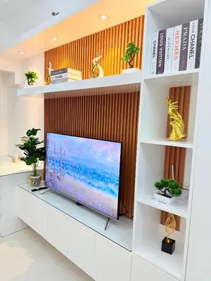 a flat screen tv sitting on a white shelf at Nestled Haven in Manila