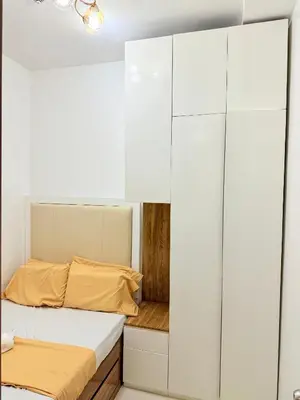 a bedroom with a bed and a closet at Nestled Haven in Manila