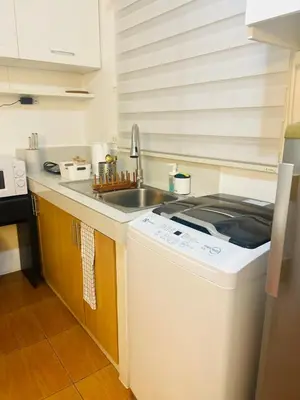 a kitchen with a sink and a washing machine at 2BR Relaxing Oasis with pool access Sorrento Oasis in Manila