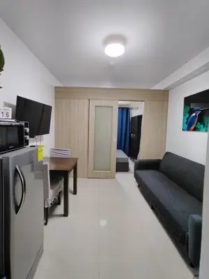 a living room with a couch and a table at 2 Bedrooms 1CR Shore 1 Residences upto 7 person-15mins walk to MOA in Manila