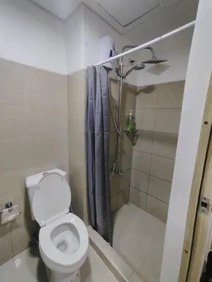 a bathroom with a toilet and a shower at 2 Bedrooms 1CR Shore 1 Residences upto 7 person-15mins walk to MOA in Manila