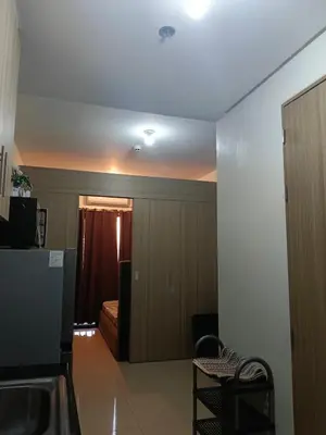 a room with a bed and a room with a kitchen at SHORE 2 Residences by ASKrentals in Manila