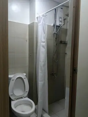 a bathroom with a toilet and a shower at SHORE 2 Residences by ASKrentals in Manila