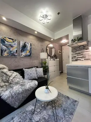 a living room with a couch and a table at R&D comfy staycation in Manila