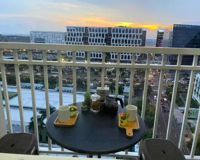 a table on a balcony with a view of a city at Las Vegas of the Philippines in Pasay Manila Luxury Near NAIA Airport x Solaire x Okada x City of Dreams and Casinos Enjoy FREE Pool Access n HighSpeed WIFI and Netflix Comfort with ResortType Living Secure Your Limited Offer This Month in Manila