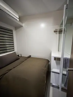 a bedroom with a large bed and a window at Spacious Homes at Shore Residence Near Mall of Asia in Manila