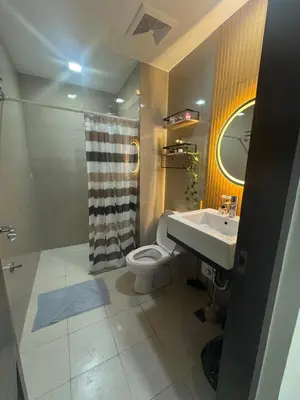 a bathroom with a sink and a toilet and a shower at Spacious Staycation with venice grand canal view in Manila