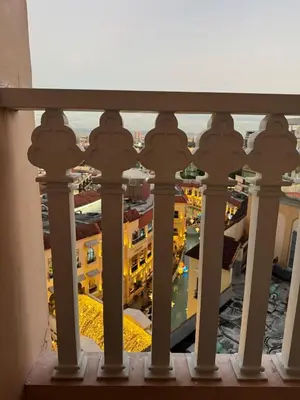 a view of a city from a balcony at Spacious Staycation with venice grand canal view in Manila