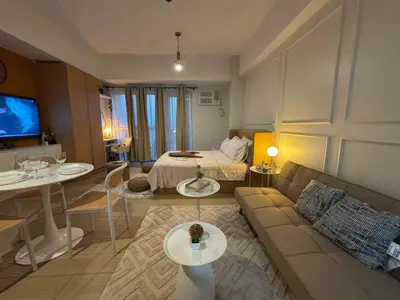 a living room with a couch and a bed at Spacious Staycation with venice grand canal view in Manila